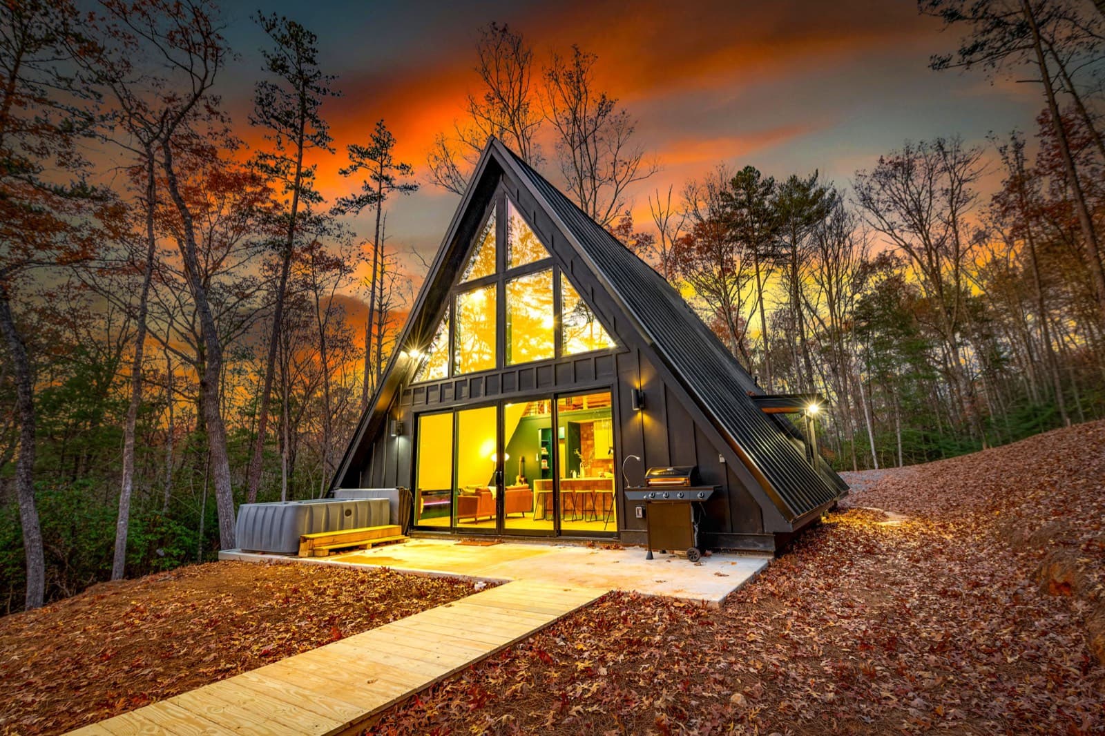 Black Ember A-frame lit up at dusk under an orange sky